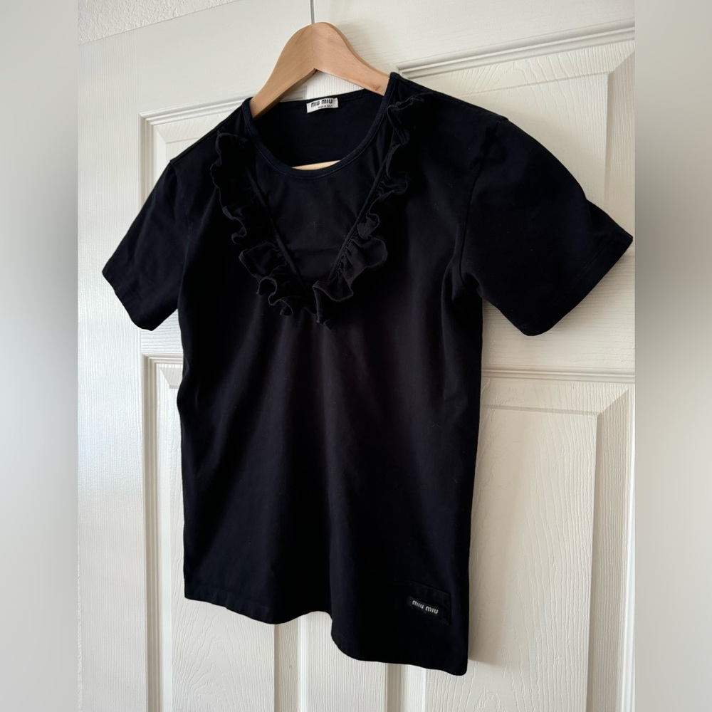 Women’s black crew neck T shirt, cotton, with frill detail around the neck line.